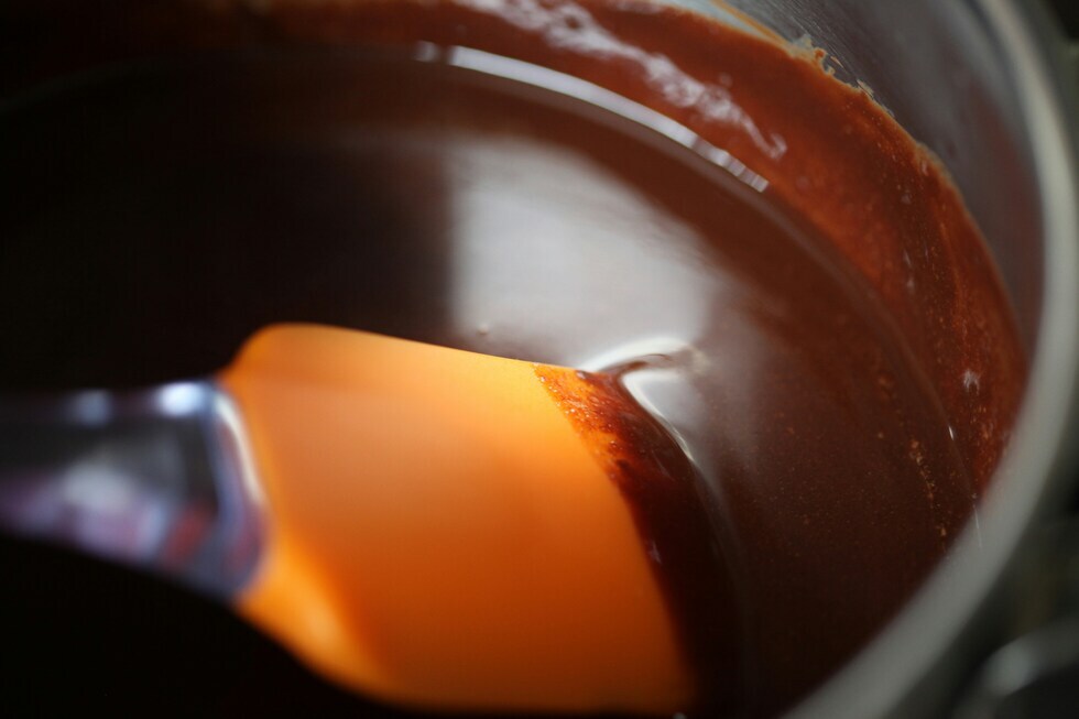 Stirring dissolved gelatin mixture on low heat for cannabis gummy recipe Stirring dissolved gelatin mixture on low heat for cannabis gummy recipe