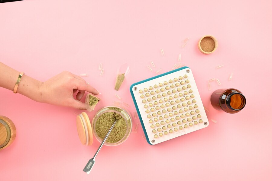 Filling silicone gummy molds with THC distillate gelatin mixture for homemade edibles Filling silicone gummy molds with THC distillate gelatin mixture for homemade edibles